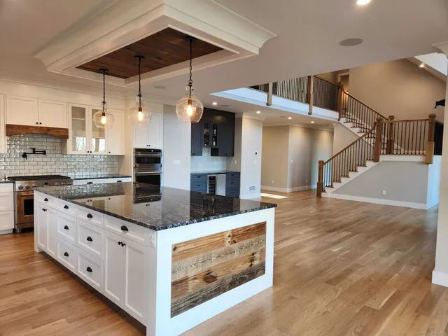 a kitchen with stainless steel appliances granite countertop a sink and cabinets