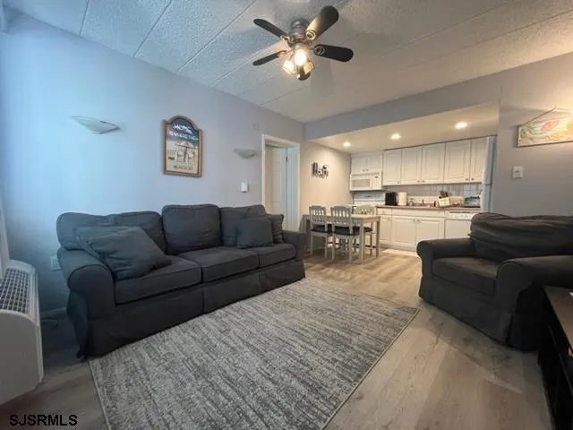 a living room with furniture and kitchen view