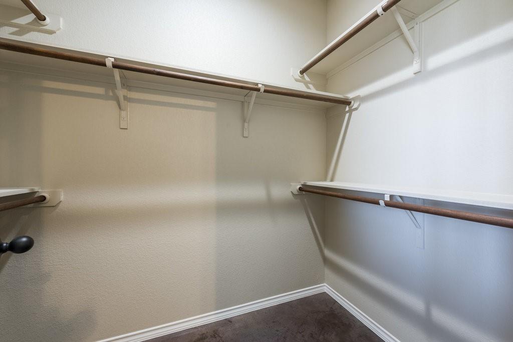 491 Jack Rabbit Lane, Unit A Buda, TX 78610 - Photo 13 of 22 Ample shelving and hanging space make this walk-in closet a practical storage solution.