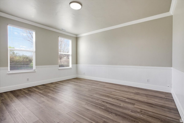 4496 West 11800 South South Jordan, UT 84009 - Photo 16 of 33 Unfurnished room featuring crown molding, a wainscoted wall, and wood finished floors