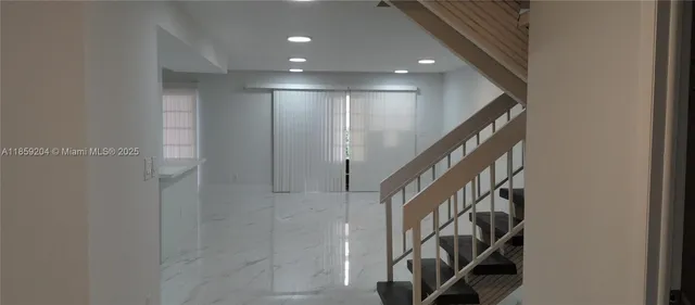 a view of an entryway with wooden floor