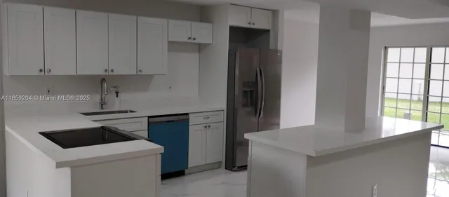 a kitchen with a sink and a stove top oven