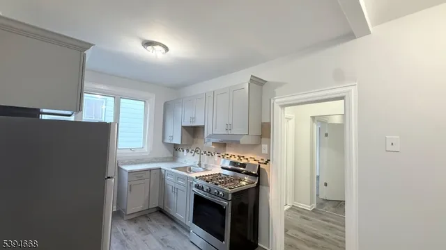 a kitchen with a sink stove and refrigerator