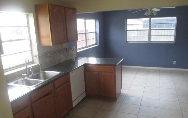 23097 Southwest 60th Way Boca Raton, FL 33428 - Photo 6 of 18 a kitchen with a sink window and cabinets