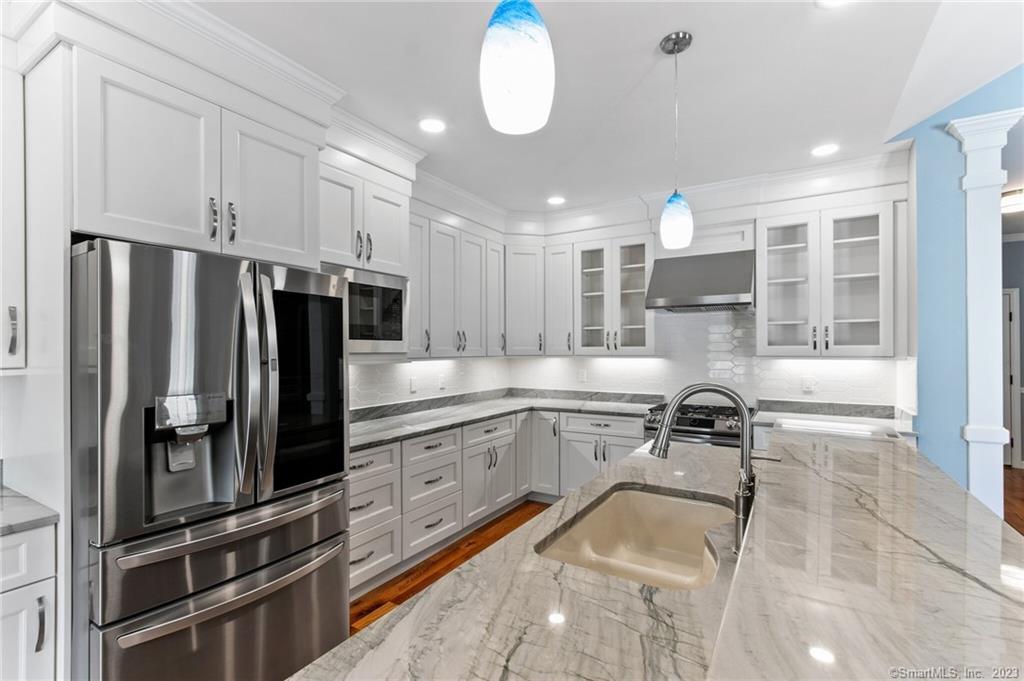 18 A Talcott Ridge Drive Middletown, CT 06457 - Photo 11 of 32 a kitchen with a refrigerator and a sink