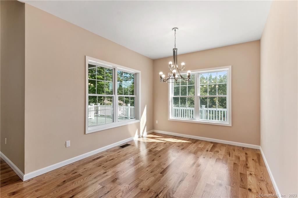 18 A Talcott Ridge Drive Middletown, CT 06457 - Photo 12 of 32 a view of an empty room with wooden floor and a window