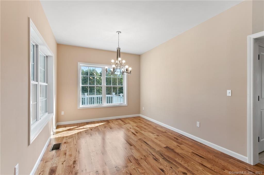 18 A Talcott Ridge Drive Middletown, CT 06457 - Photo 14 of 32 a view of an empty room with window and wooden floor