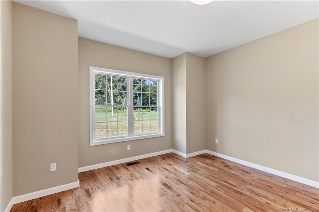 18 A Talcott Ridge Drive Middletown, CT 06457 - Photo 15 of 32 a view of an empty room with wooden floor and a window