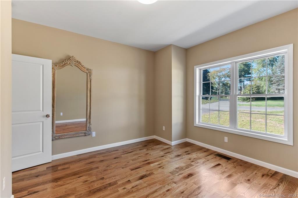 18 A Talcott Ridge Drive Middletown, CT 06457 - Photo 16 of 32 a view of an empty room with wooden floor and a window