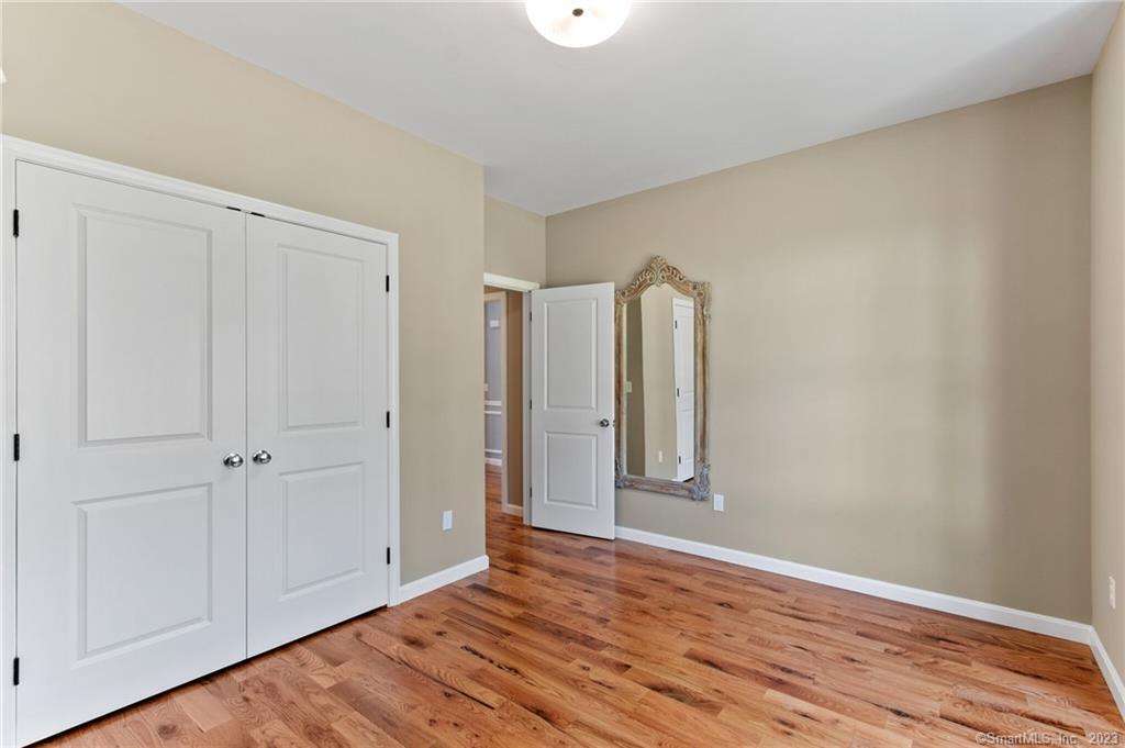 18 A Talcott Ridge Drive Middletown, CT 06457 - Photo 17 of 32 a view of an empty room with wooden floor and closet
