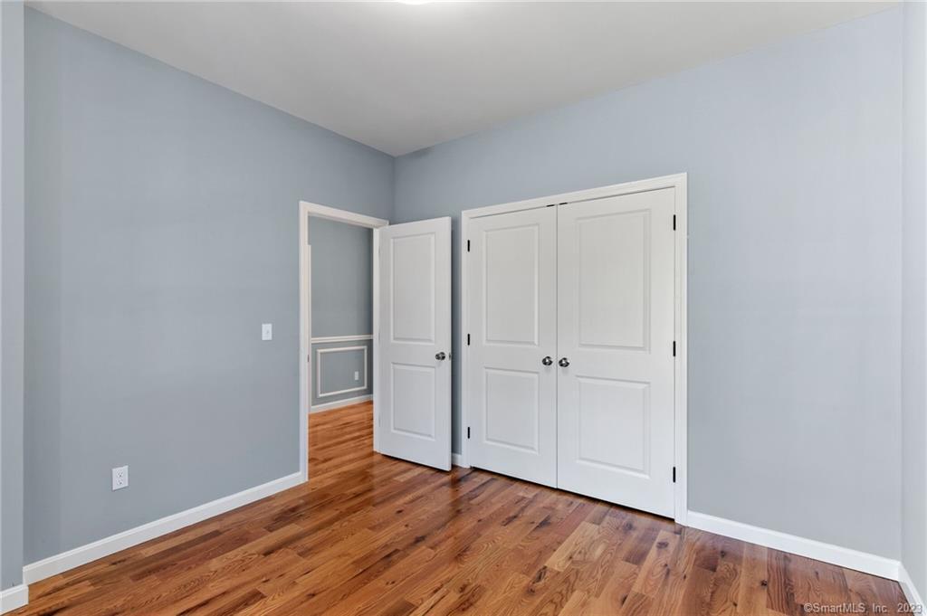 18 A Talcott Ridge Drive Middletown, CT 06457 - Photo 19 of 32 a view of an empty room and wooden floor