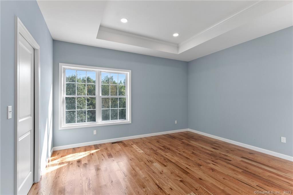 18 A Talcott Ridge Drive Middletown, CT 06457 - Photo 21 of 32 a view of empty room with wooden floor and fan