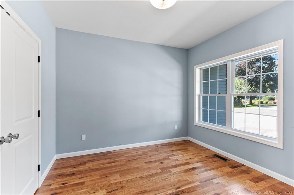 18 A Talcott Ridge Drive Middletown, CT 06457 - Photo 28 of 32 a view of empty room with wooden floor and fan