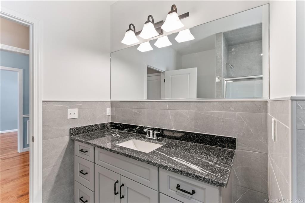 18 A Talcott Ridge Drive Middletown, CT 06457 - Photo 30 of 32 a bathroom with a sink and a mirror