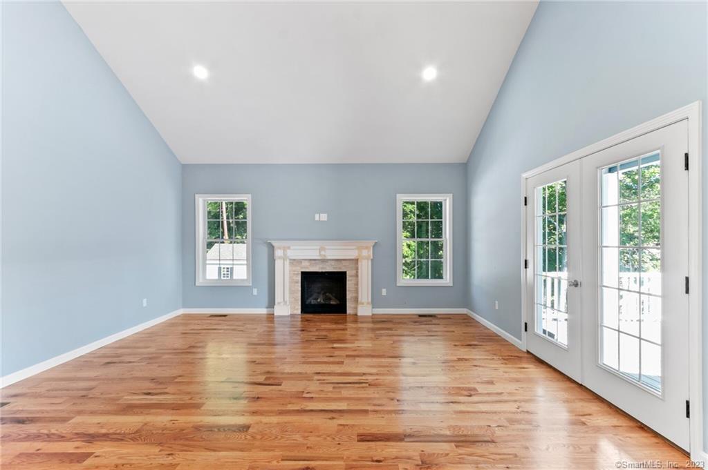 18 A Talcott Ridge Drive Middletown, CT 06457 - Photo 3 of 32 a view of empty room with wooden floor and fireplace