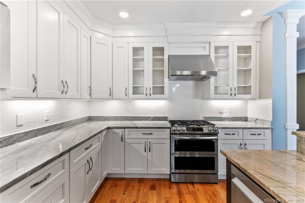 18 A Talcott Ridge Drive Middletown, CT 06457 - Photo 10 of 32 a kitchen with granite countertop white cabinets and stainless steel appliances