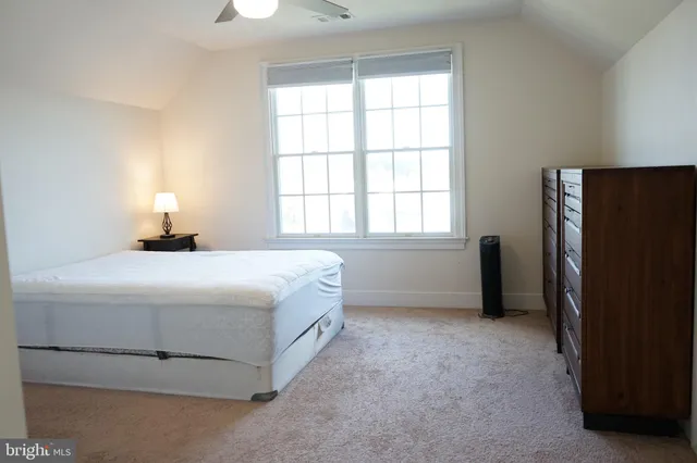 a bedroom with a bed closet and a window