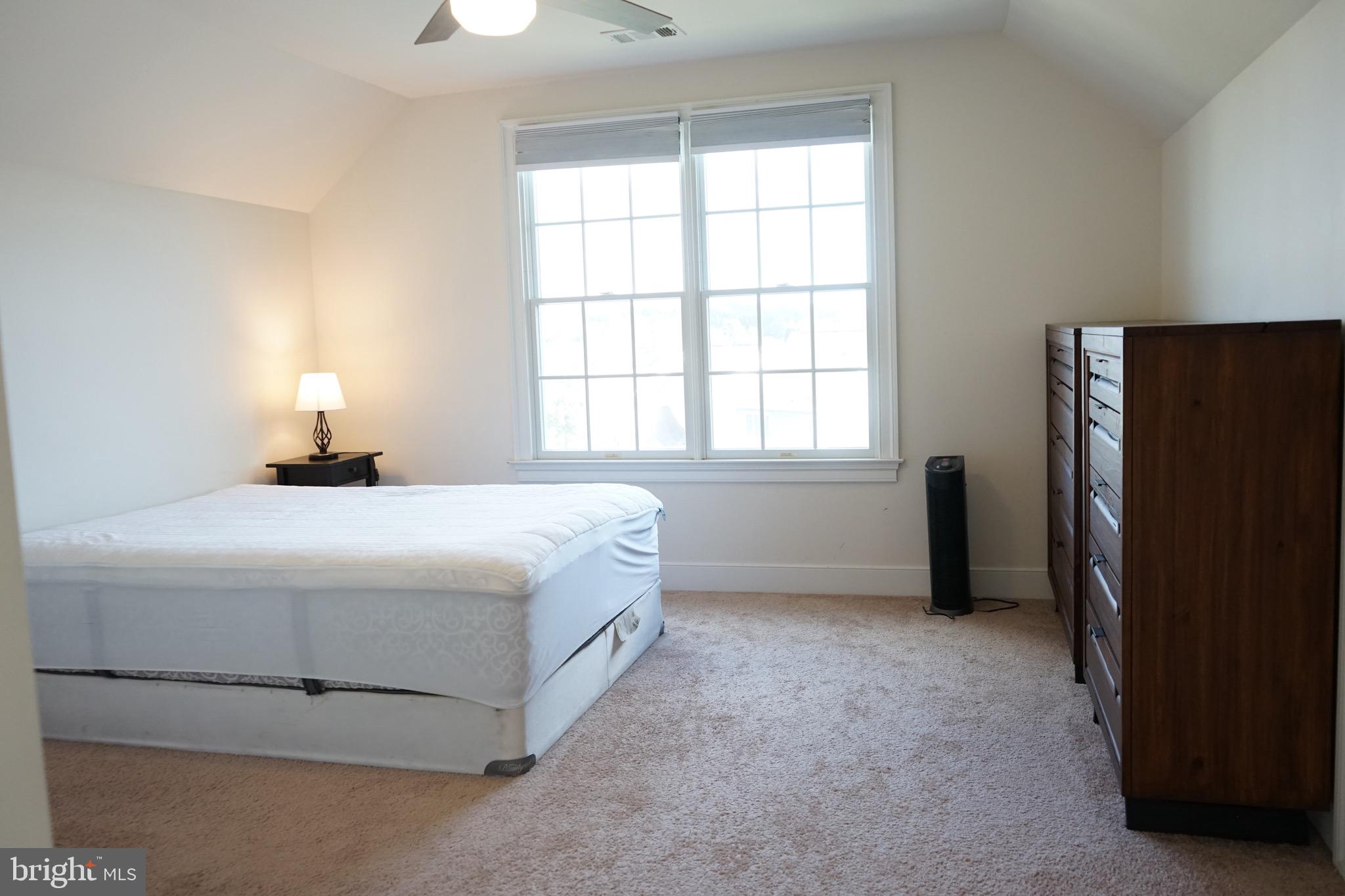 a bedroom with a bed closet and a window
