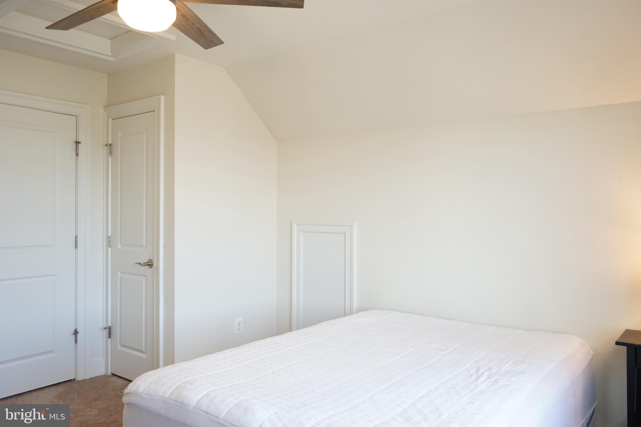 3937 Addison Woods Road Frederick, MD 21704 - Photo 2 of 13 a bedroom with a bed and a chandelier fan