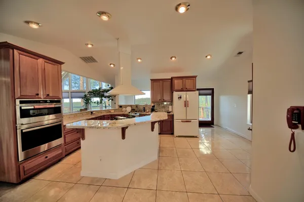 a kitchen with stainless steel appliances a refrigerator sink and stove