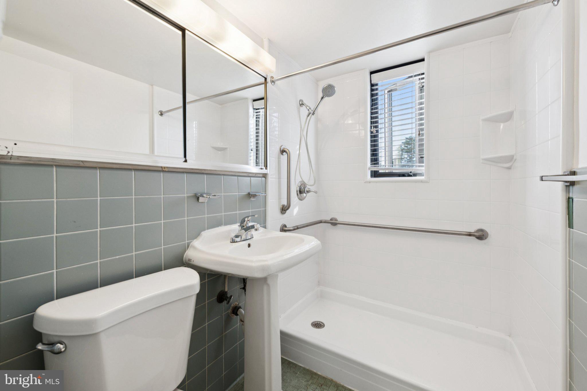 5410 Connecticut Avenue Northwest, Unit 315 Washington, DC 20015 - Photo 11 of 22 a bathroom with a sink a toilet and shower