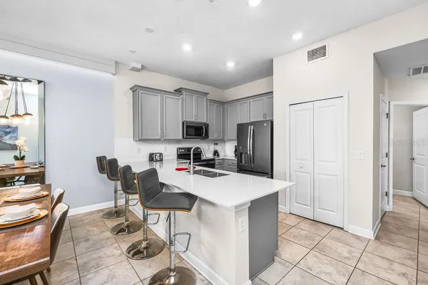 a kitchen with stainless steel appliances a refrigerator stove microwave and cabinets