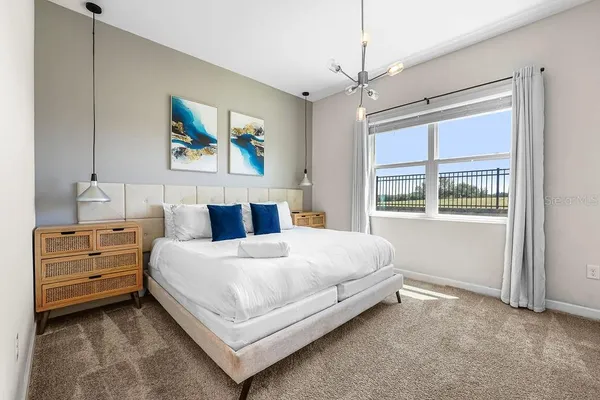 a bedroom with a bed and a window