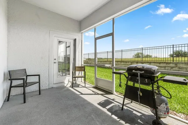 a view of a two chairs and table in the patio