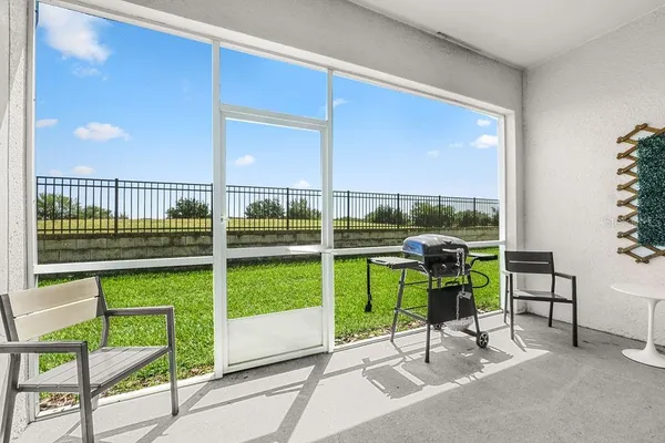 a view of a chair and tables in the balcony