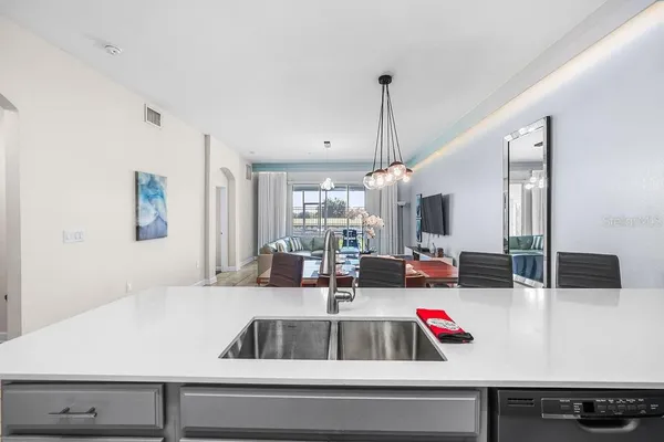 a kitchen with kitchen island a white counter space and stainless steel appliances