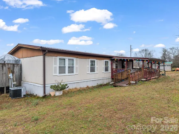 a view of a house with backyard porch and sitting area