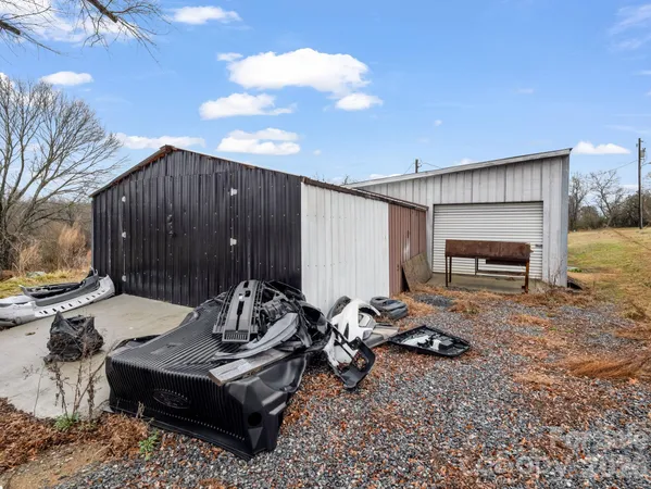 a backyard of a house with barbeque oven table and chairs
