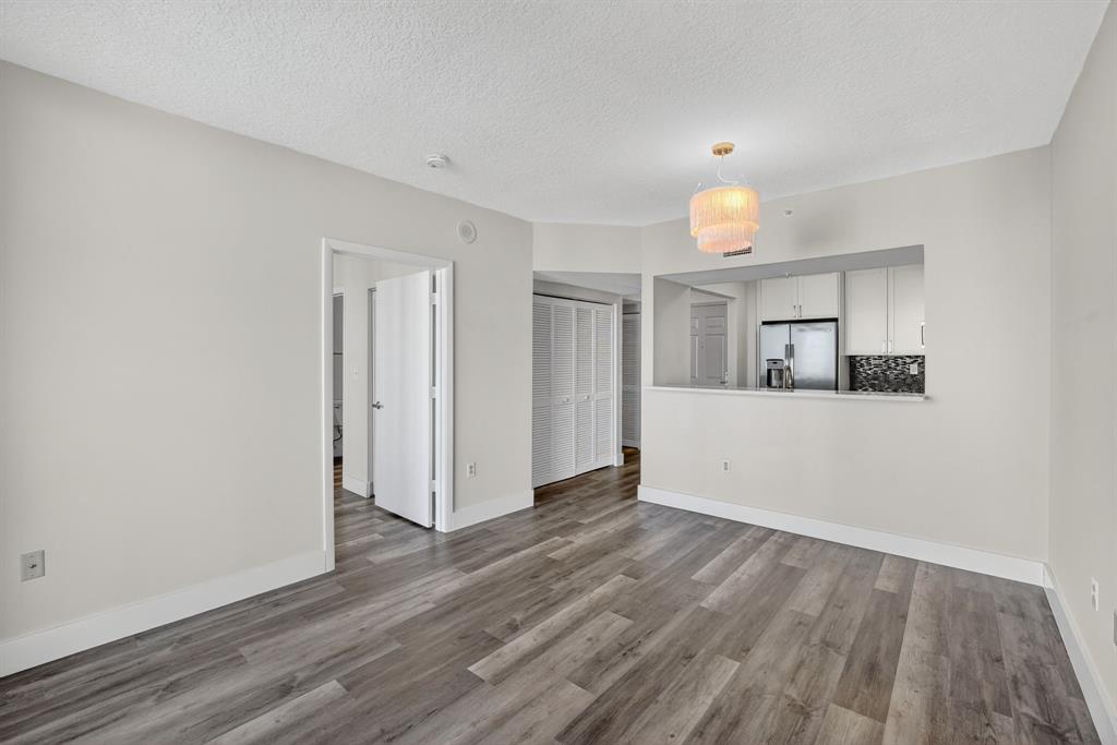 3020 Northeast 32nd Avenue, Unit 1207 Fort Lauderdale, FL 33308 - Photo 11 of 69 a view of a room with wooden floor and a window