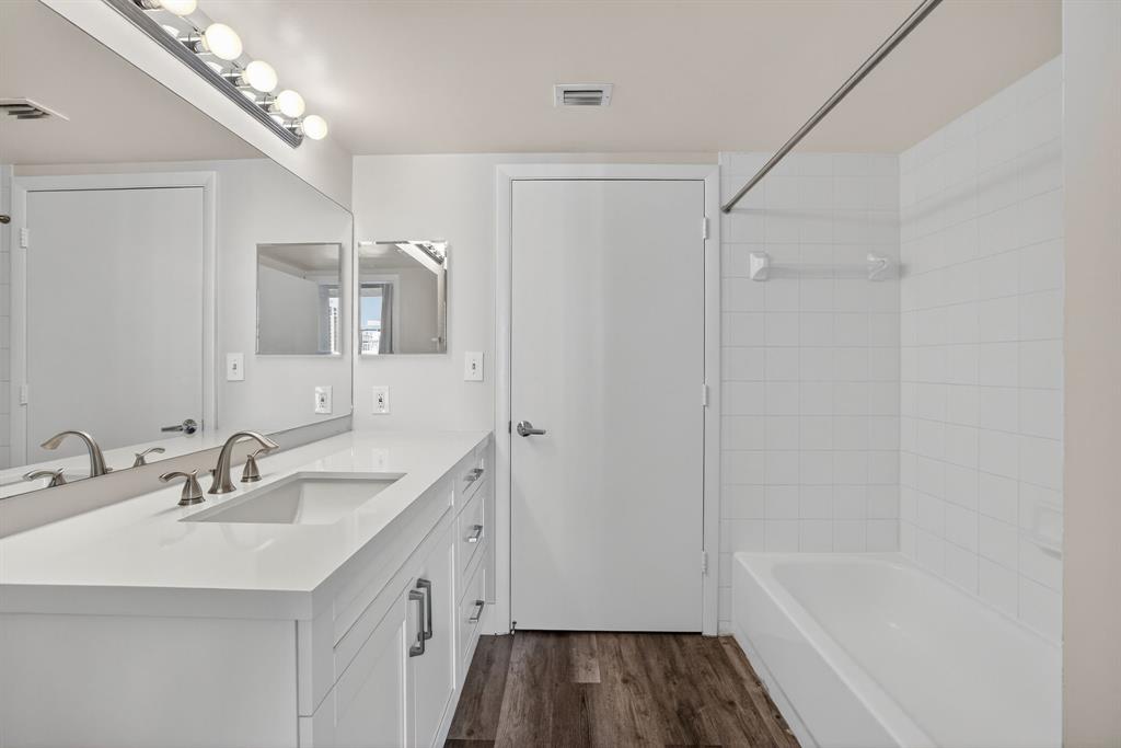 3020 Northeast 32nd Avenue, Unit 1207 Fort Lauderdale, FL 33308 - Photo 12 of 69 a bathroom with a sink a tub and a mirror