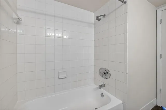 a view of an empty room with wooden floor and closet