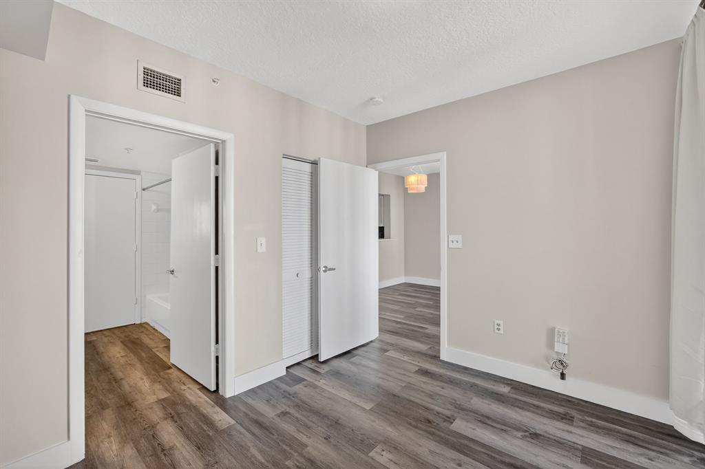 3020 Northeast 32nd Avenue, Unit 1207 Fort Lauderdale, FL 33308 - Photo 16 of 69 a view of an empty room with wooden floor and closet