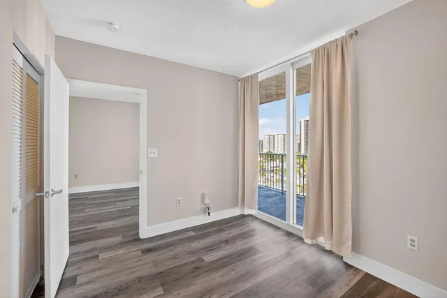 a view of a room with wooden floor