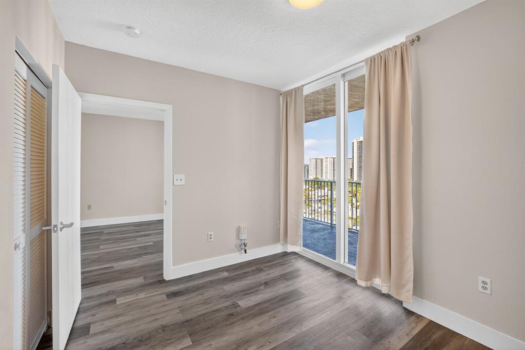3020 Northeast 32nd Avenue, Unit 1207 Fort Lauderdale, FL 33308 - Photo 17 of 69 an empty room with wooden floor and windows