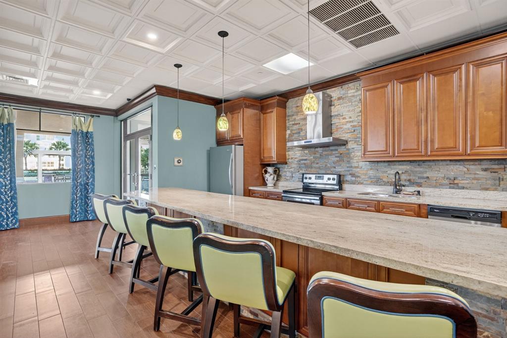 3020 Northeast 32nd Avenue, Unit 1207 Fort Lauderdale, FL 33308 - Photo 38 of 69 a kitchen with a table chairs sink and cabinets