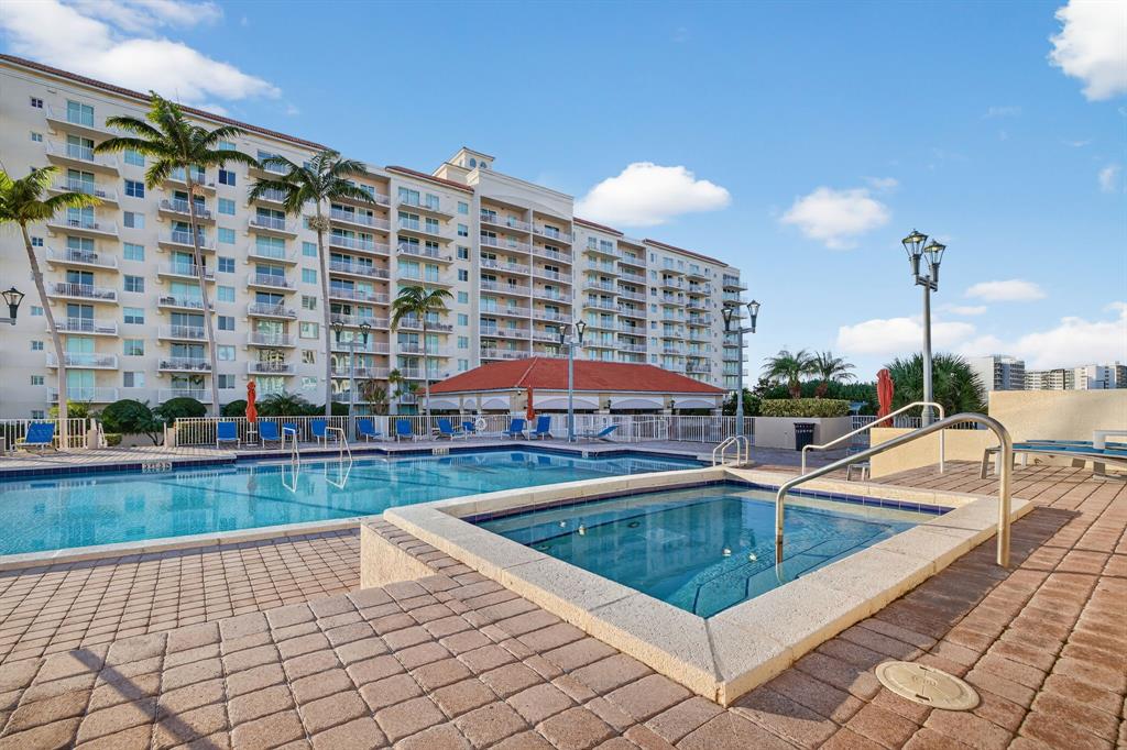 3020 Northeast 32nd Avenue, Unit 1207 Fort Lauderdale, FL 33308 - Photo 49 of 69 a view of a swimming pool and lounge chairs