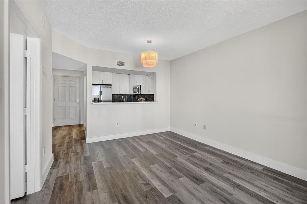 3020 Northeast 32nd Avenue, Unit 1207 Fort Lauderdale, FL 33308 - Photo 7 of 69 a view of a kitchen with wooden floor and electronic appliances