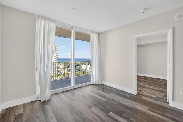 a view of a room with wooden floor and a window