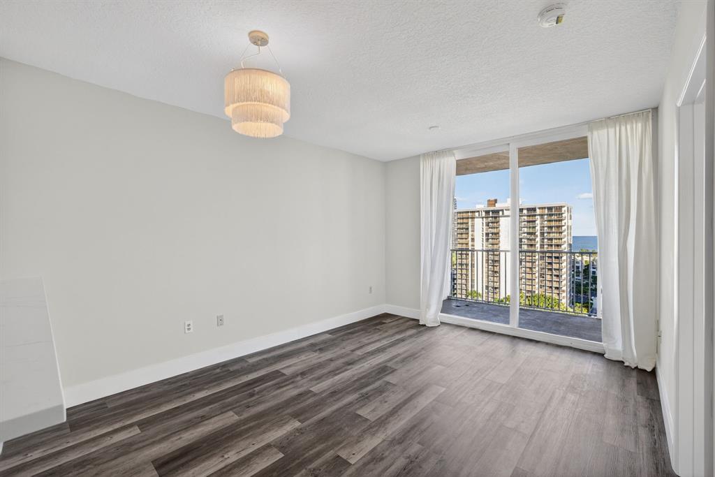 3020 Northeast 32nd Avenue, Unit 1207 Fort Lauderdale, FL 33308 - Photo 10 of 69 an empty room with wooden floor and windows