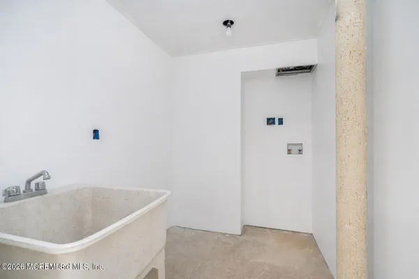 a bathroom with a tub and sink