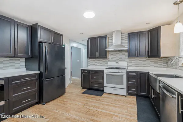 a kitchen with kitchen island granite countertop wooden cabinets and stainless steel appliances