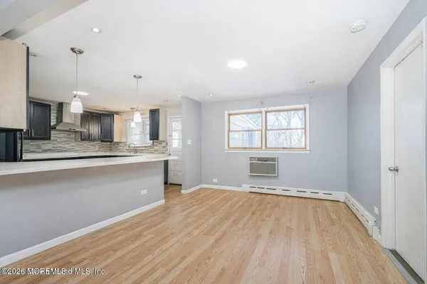 a view of wooden floor and windows in a room
