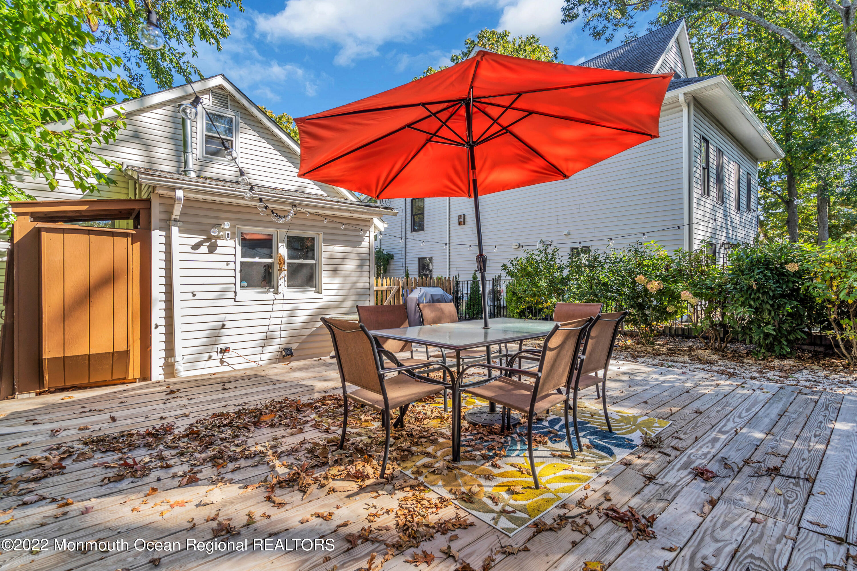 176 Pinehurst Road Brick, NJ 08723 - Photo 34 of 55 a patio with a table and chairs under an umbrella