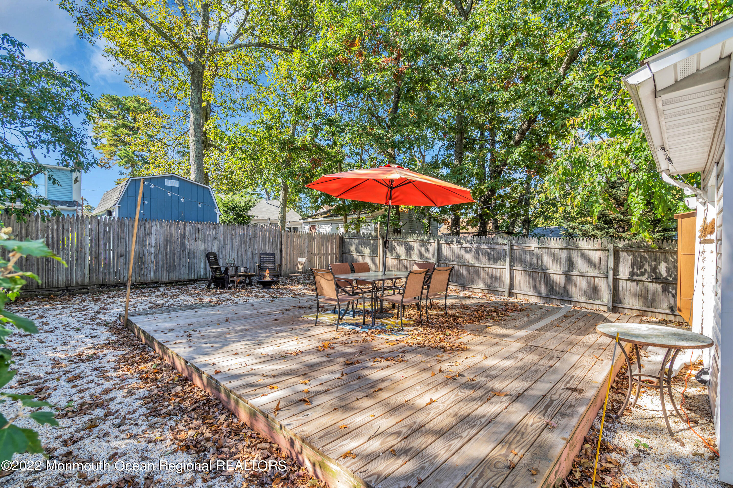 176 Pinehurst Road Brick, NJ 08723 - Photo 36 of 55 a view of a patio with a table and chairs under an umbrella