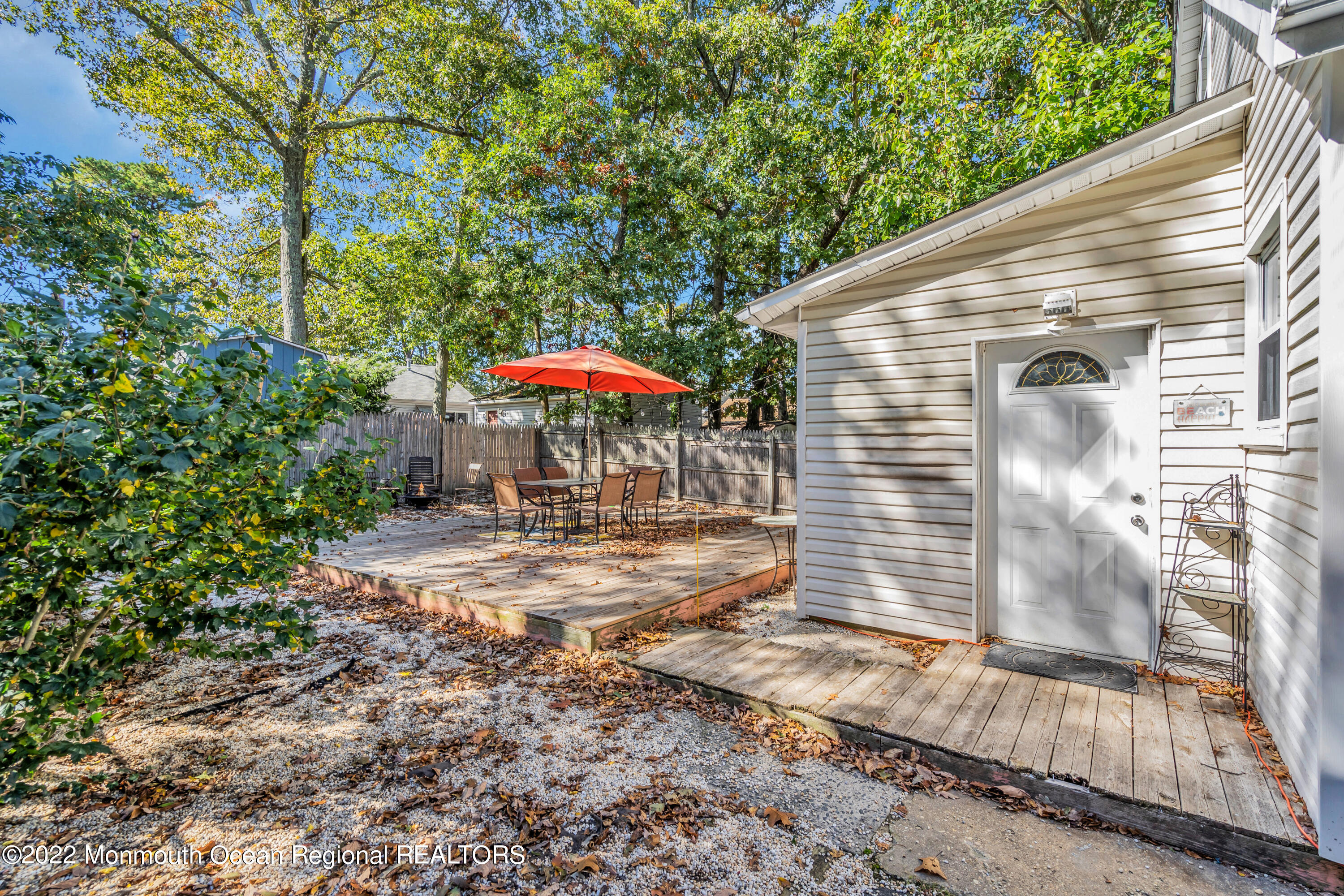 176 Pinehurst Road Brick, NJ 08723 - Photo 38 of 55 a view of a patio with a table and chairs under an umbrella