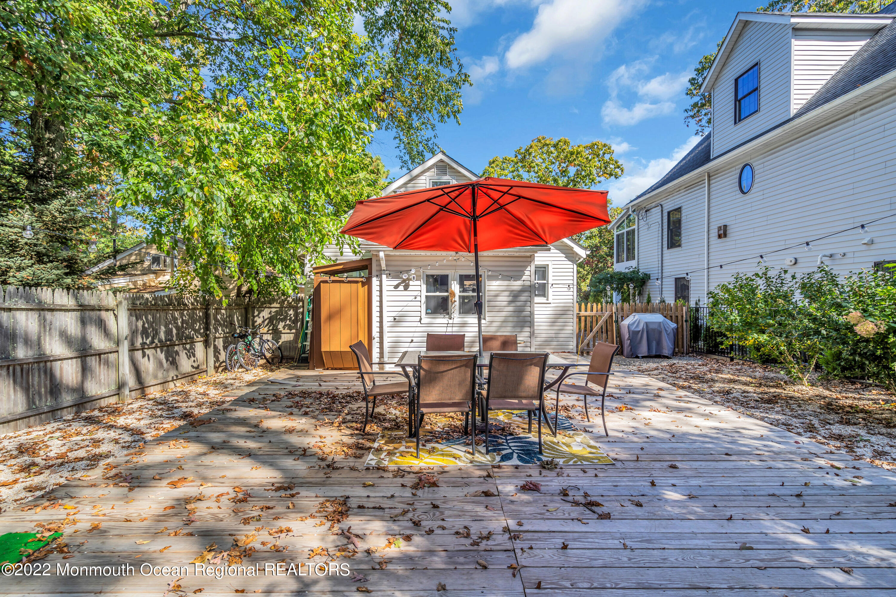 176 Pinehurst Road Brick, NJ 08723 - Photo 39 of 55 a view of a patio with a table and chairs under an umbrella